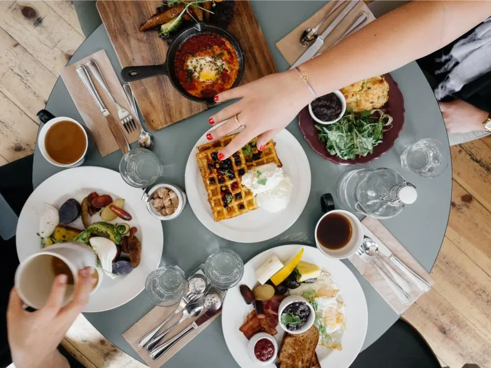 Overhead view of a brunch table with waffles, eggs and coffee
